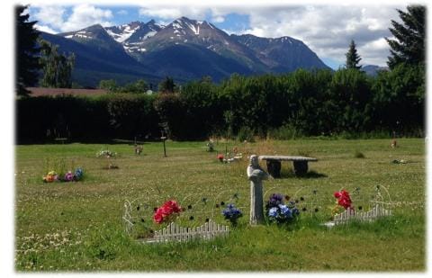 Decorations in a cemetery in front of a mountain
